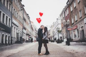 Young man and women on romantic walk with Valentine's Day balloons